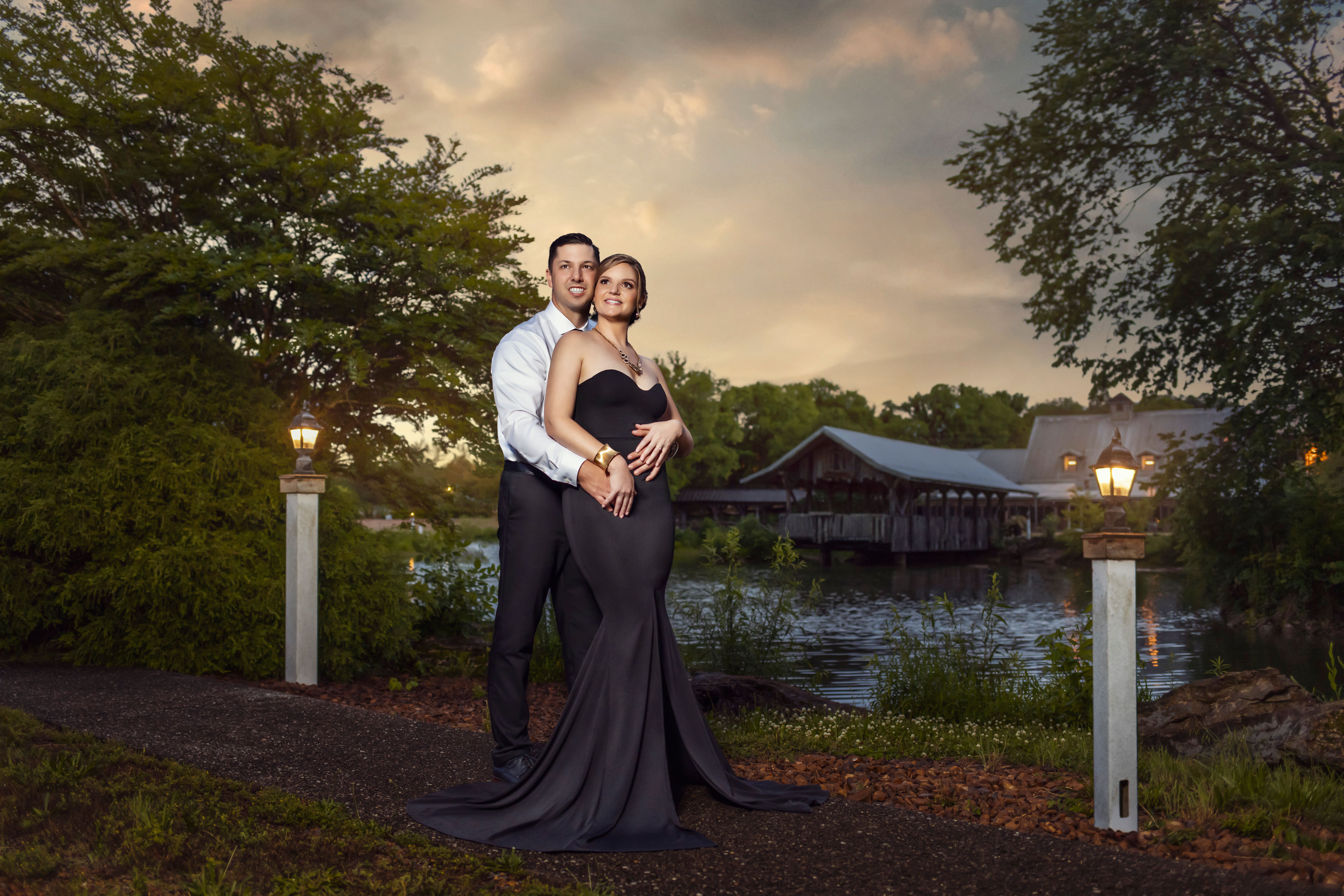 A couple embracing with a city skyline behind them.