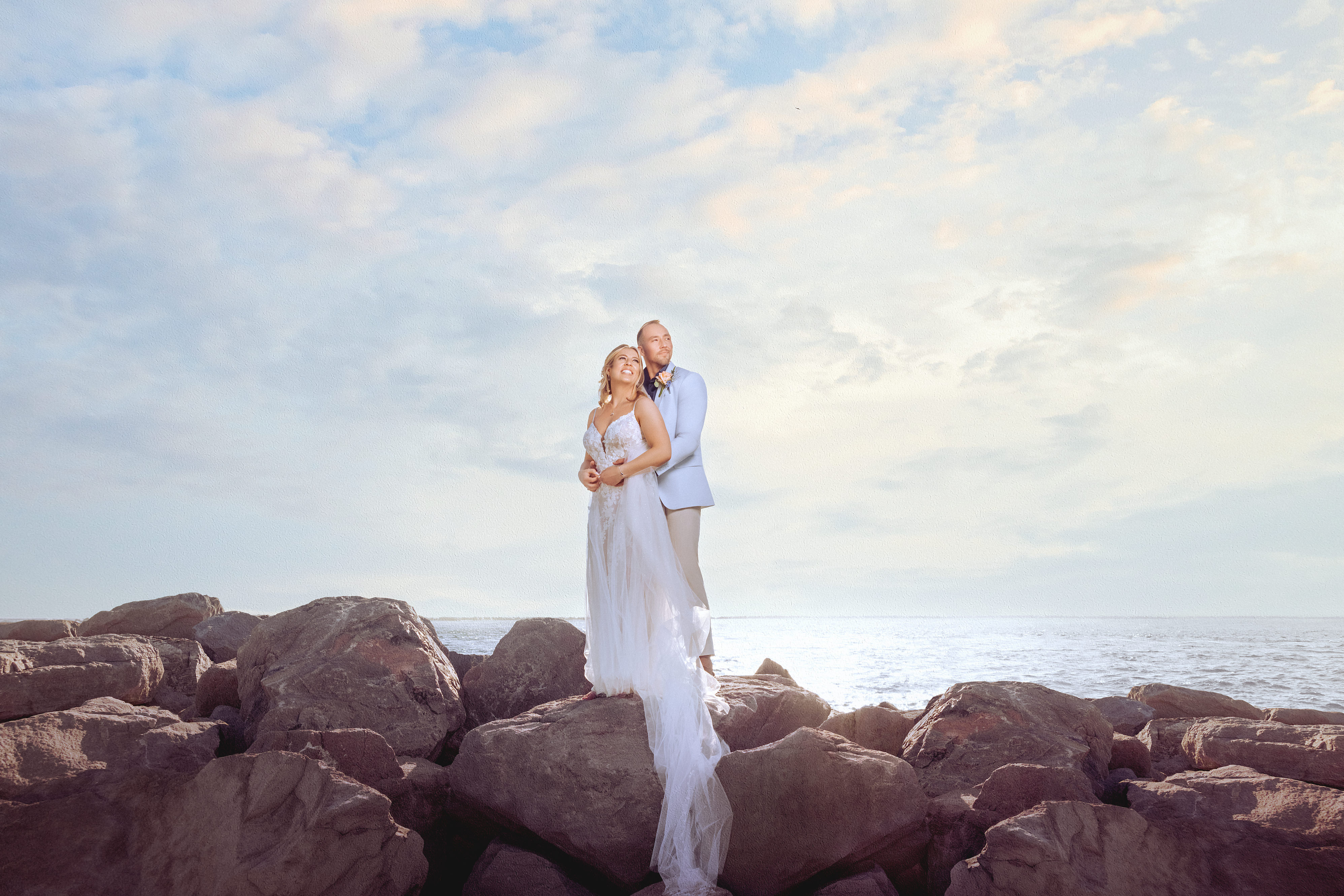 A couple on a lakeside terrace at golden hour.